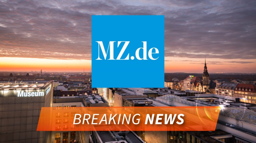 Im Hintergrund ist eine Stadt zu sehen. Vorne ist das blaue Logo von MZ zu sehen und darunter steht "Breaking News"