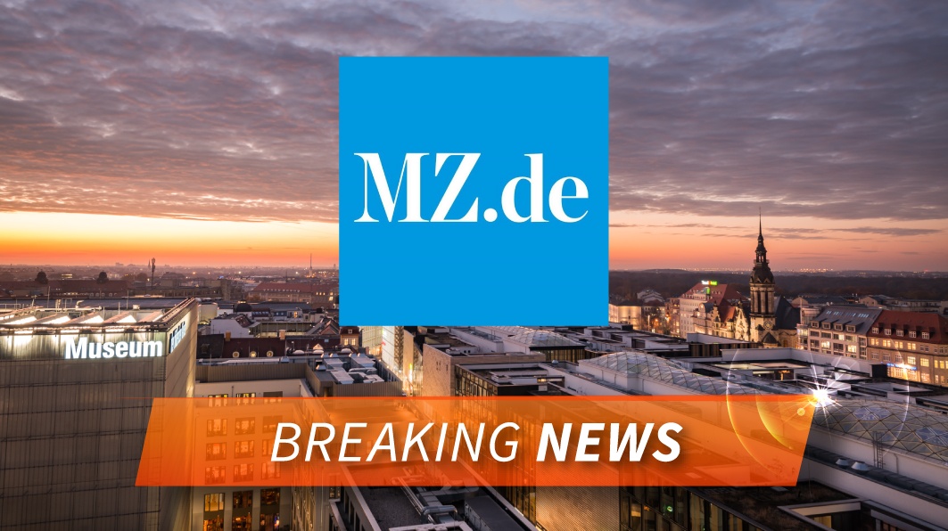 Im Hintergrund ist eine Stadt zu sehen. Vorne ist das blaue Logo von MZ zu sehen und darunter steht "Breaking News"