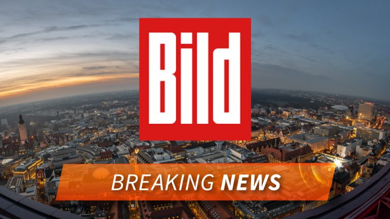 Im Hintergrund ist eine Stadt zu sehen. Vorne ist das rote Logo von Bild zu sehen und darunter steht "Breaking News"