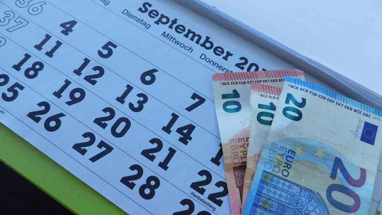 Auf einem Kalender liegen drei Eurogeldscheine.